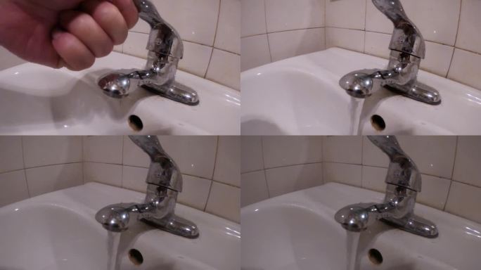 打开水管往洗脸池里放水