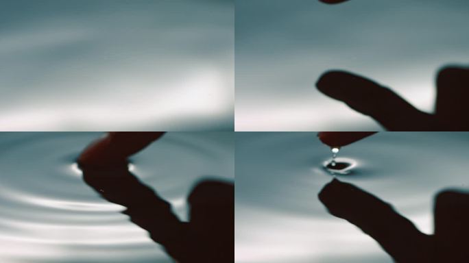 手指尖触碰水面湖面荡起水波纹液体水波纹