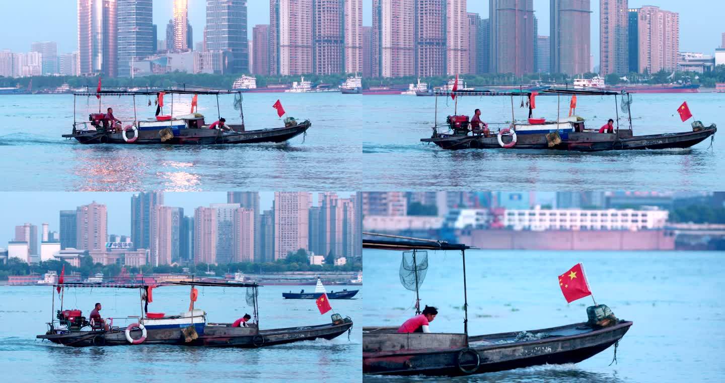 武汉武昌长江江岸上行驶的渔船国旗飘扬