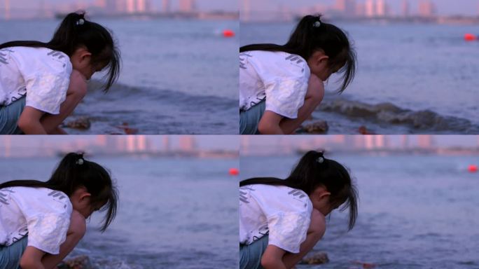 武汉武昌江滩傍晚夕阳余晖下玩水的女孩