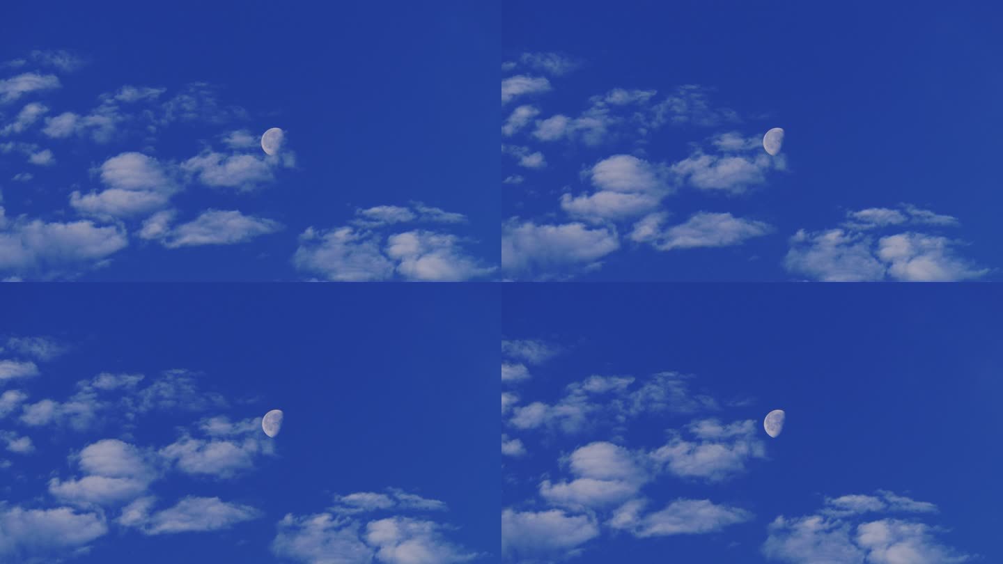 蓝天中的云朵经过月亮