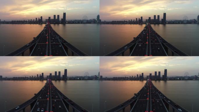 航拍城市的夕阳与跨江大桥4K