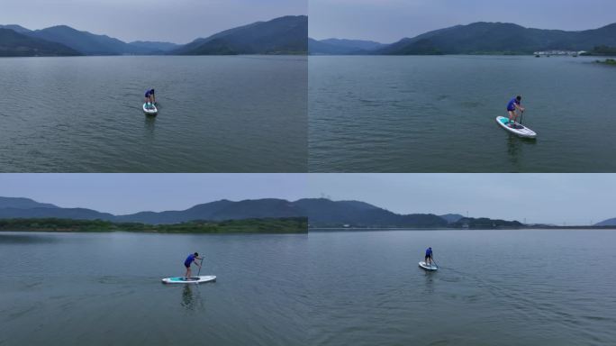 一名男子站在水板上，夏季户外划船