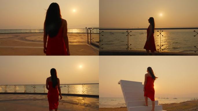 夕阳下晚霞里穿着红色裙子的美女背影剪影