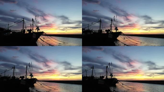 傍晚渔港停靠在晚霞里的渔船