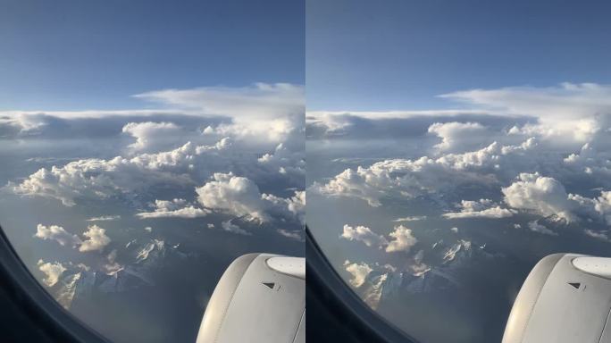飞机旅行飞过意大利北部雪山的壮观云海景象