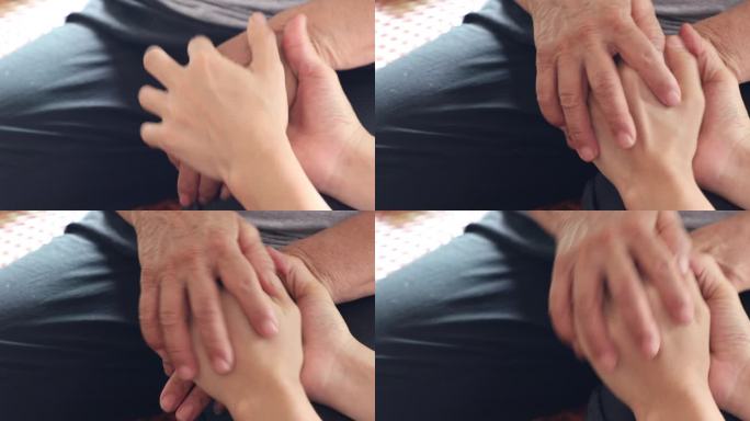 关爱抚摸老人的手