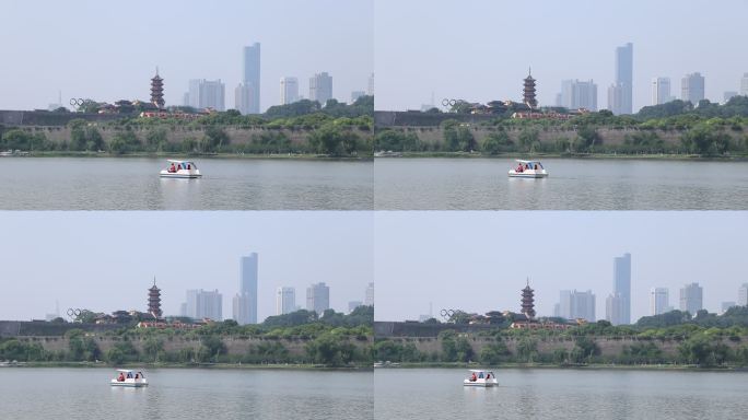 一只游船在南京玄武湖面上驶过鸡鸣寺