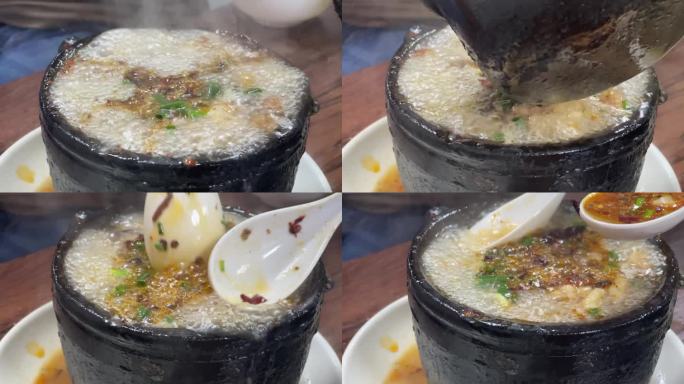 热腾腾的的砂锅烫油泼辣子勺子舀汤