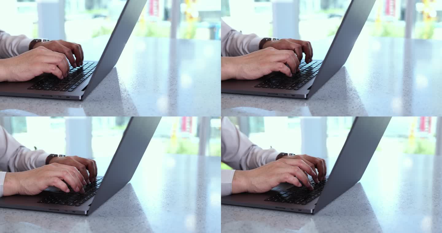 一双手使用电脑敲击键盘