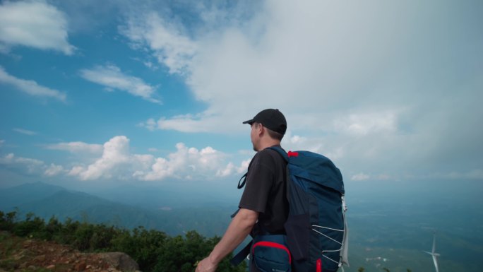 徒步背包登山攀登驴行人物站在高山高处山巅