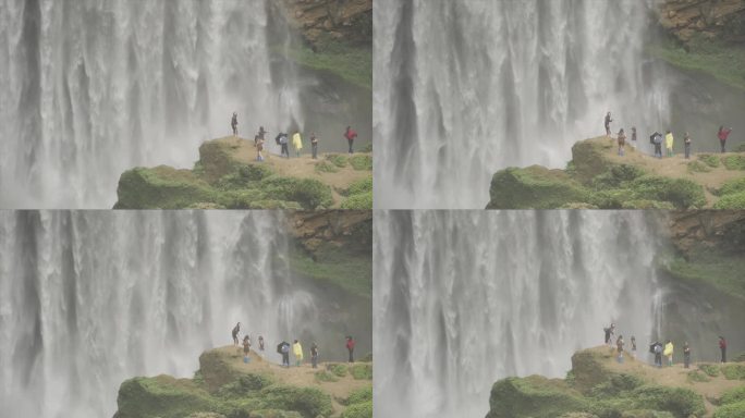 一群人瀑布前拍照打卡户外探险飞流直下溪流