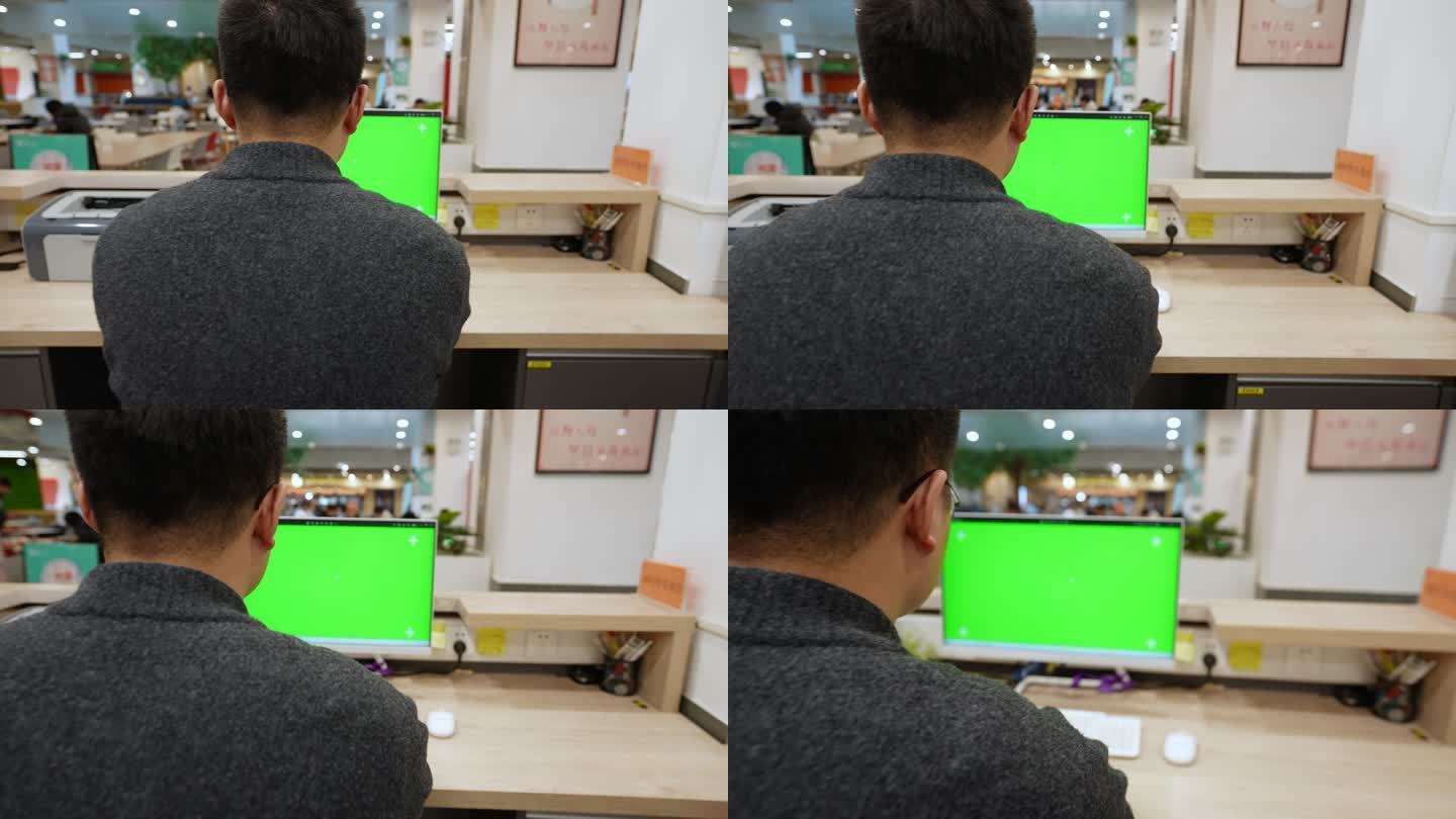 男子在绿色屏幕的电脑前办公 背影