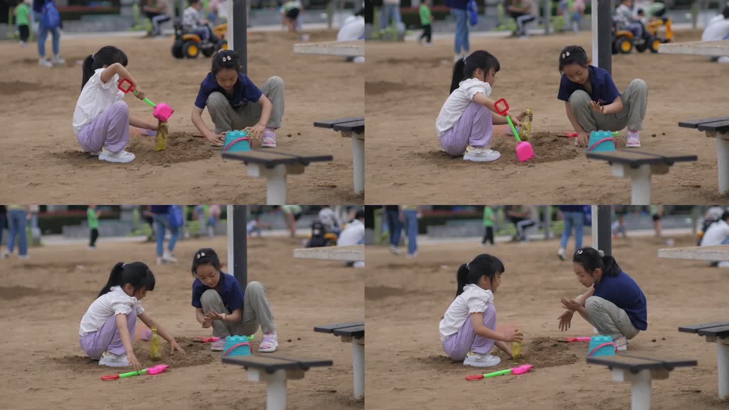 两个小女孩在沙滩玩沙子