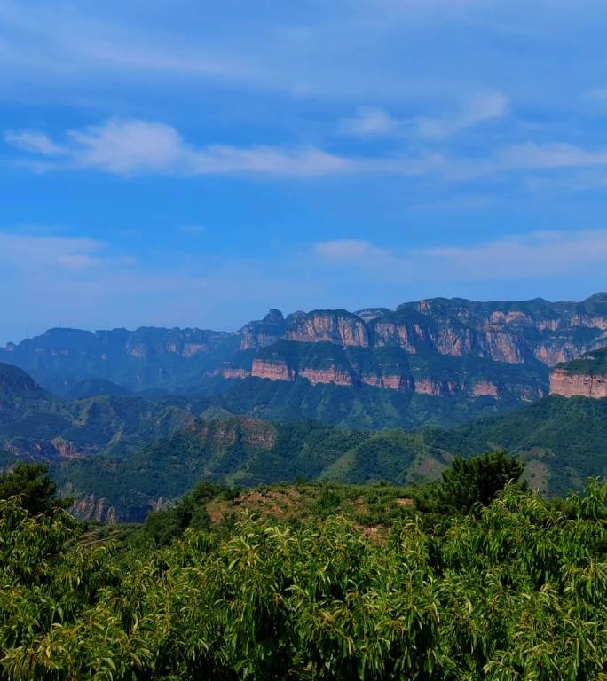 竖屏蓝天白云下层次分明的大山