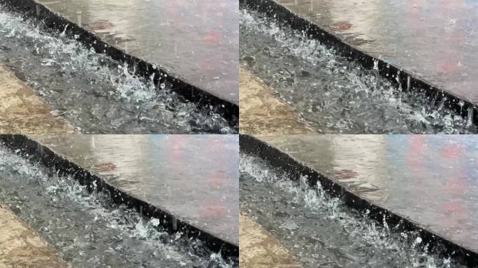 暴雨天气城市建筑的水沟积水和滴水溅起水花