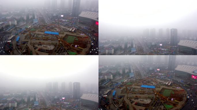 俯拍建设中的武汉光谷广场圆盘转盘大雾