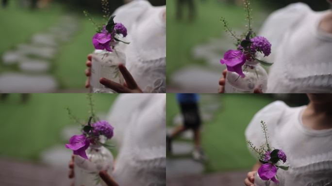 小花童手捧鲜花紫色花朵女孩白衣草坪婚礼