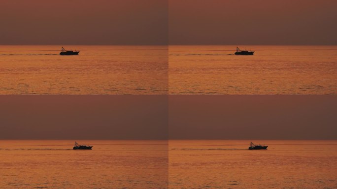 北海海上落日余晖下缓慢行驶的一艘渔船