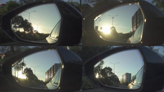 汽车行驶中后视镜 倒影沿途风光日落