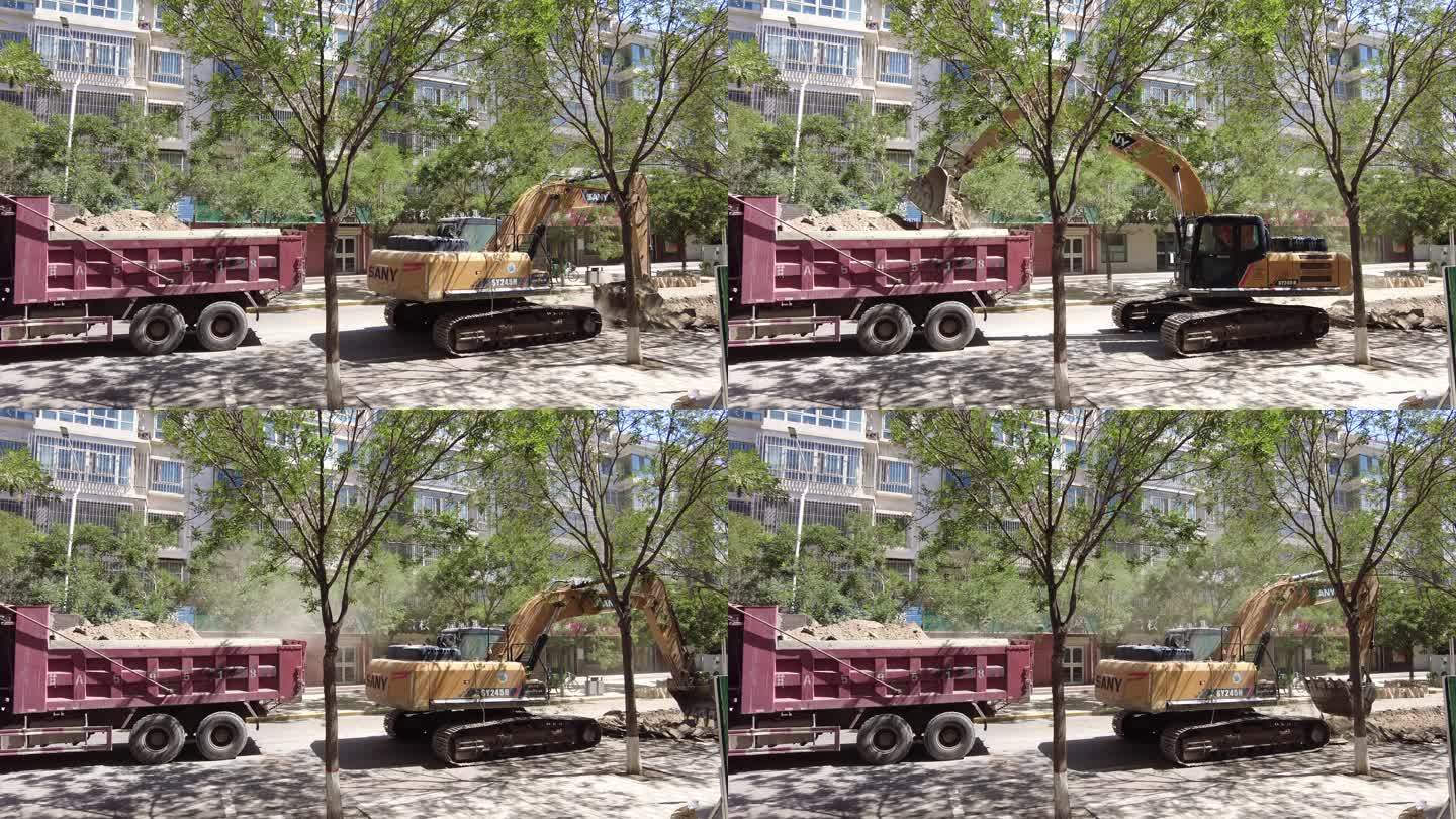 挖掘机揭去城区柏油路面装入渣土车