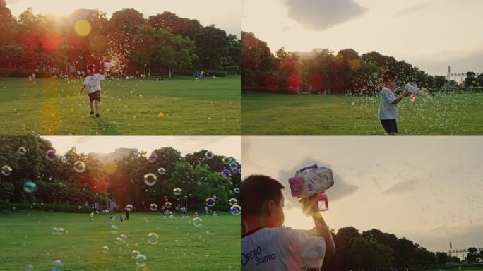 公园草地上玩泡泡机的开心小男孩