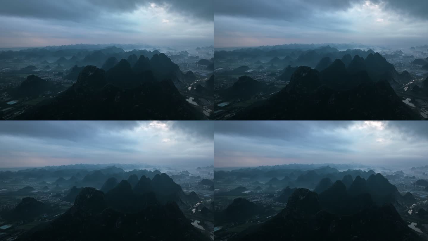 黎明时分桂林城市里的山和上空的乌云