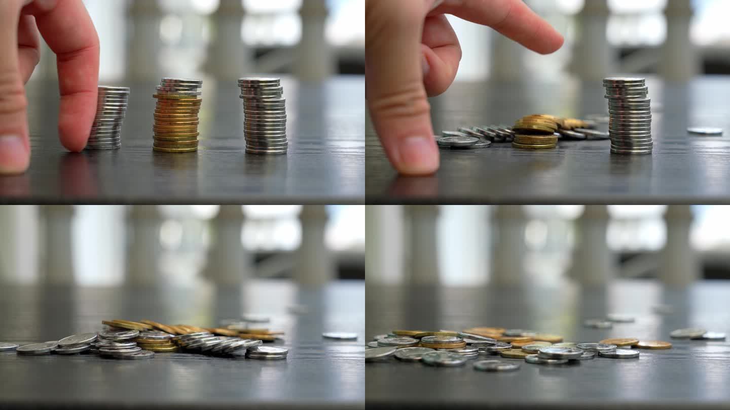 一个人在桌面上堆叠硬币