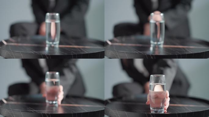一只手将水杯推到面前