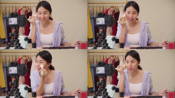 慢动作--美女博主呈现美容化妆品坐在前置摄像头录制视频。快乐美丽的年轻亚洲妇女使用化妆品评论组成教程