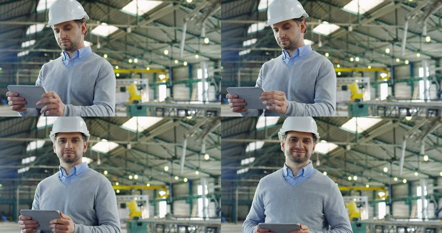 在他的平板电脑上，一个戴着头盔、带着带子和滚动的有吸引力的男性工程师的画像，比在大型工业设施中看着相