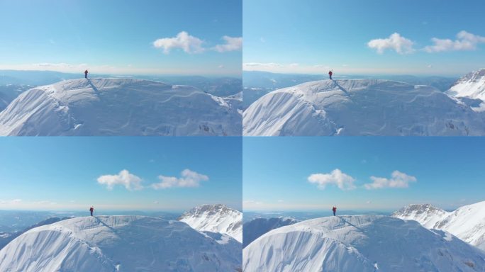 空中: 壮观的阳光明媚的山脉环绕着一个无法辨认的滑雪者, 在滑雪前, 在覆盖山坡的新鲜粉末雪中滑雪,