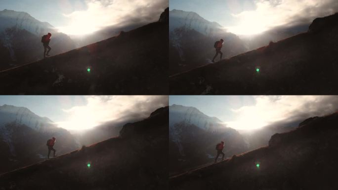 非常长的镜头鸟图, 一个女孩走在山边的史诗镜头, 作为美丽的日落中的剪影。一个戴着背包爬上上坡的女孩