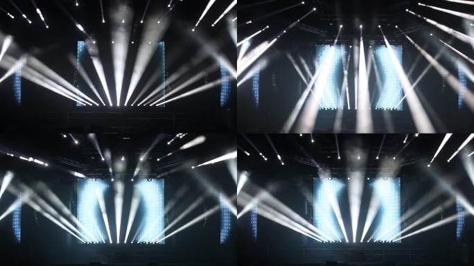五颜六色明亮的舞台灯光在音乐会蓝色和白色的灯光聚光灯