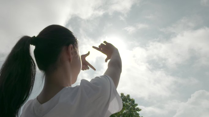 唯美女生仰望天空未来充满希望触摸阳光手势