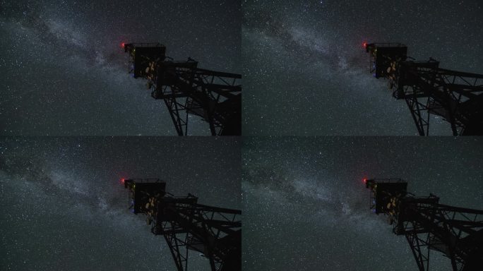 银河星系在星空夜的流逝中飞过通讯塔