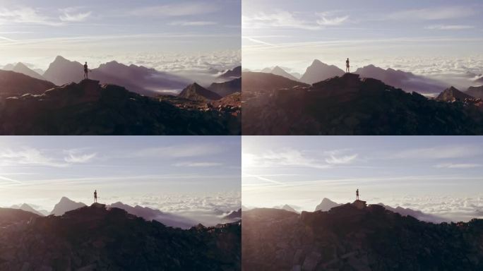空中步道跑步者站在山顶目标看地平线视图。无人机拍摄。户外的野生自然在日出或日落背光。训练活动、运动、