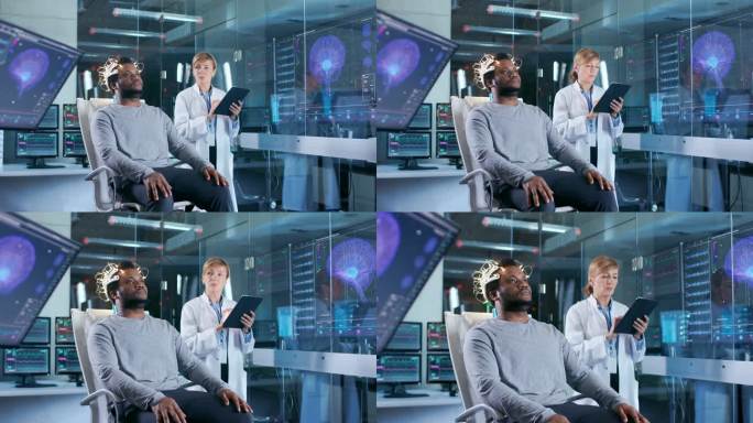 男子穿着脑波扫描耳机坐在椅子上, 而科学家与平板电脑监督过程。现代脑研究中的实验室监测显示英语阅读和
