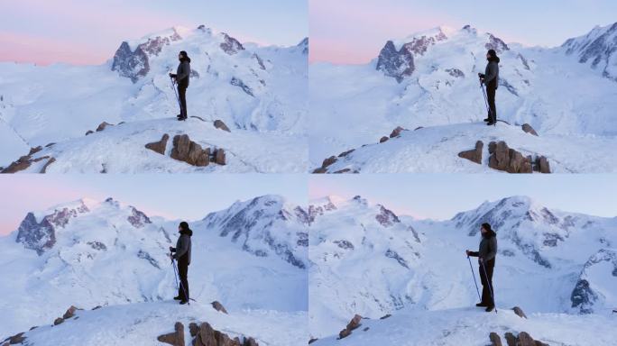 男子与登山棒站在山顶，俯瞰景观