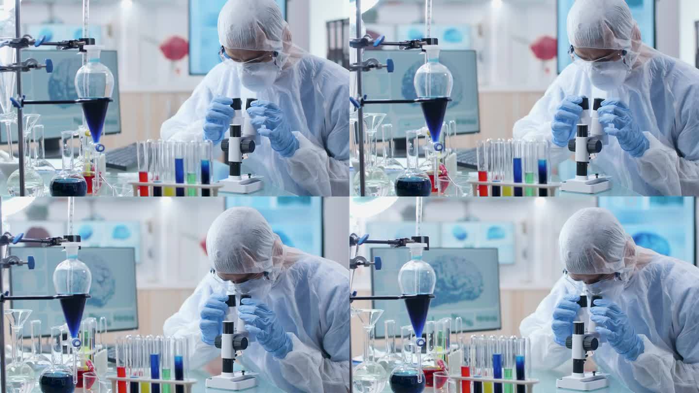 在高端实验室中，化学家在显微镜前观察