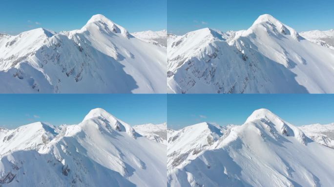 空中: 在风景如画的阳光明媚的阿尔卑斯山拍摄雄伟的雪山山脊的电影。沿着令人叹为观止的山脉飞行, 被刚