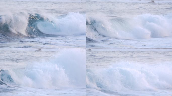 慢动作，特写：洋桶波到达阳光明媚的海滩后，会疯狂地飞溅。美丽的泡沫海洋膨胀在清爽的夏日早晨的特写。放