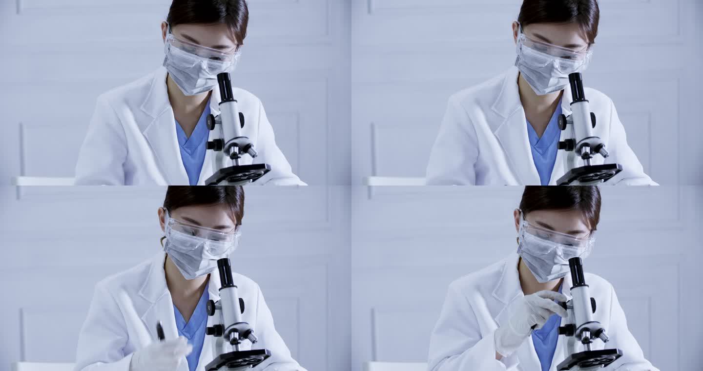 在实验室用显微镜工作的科学家
