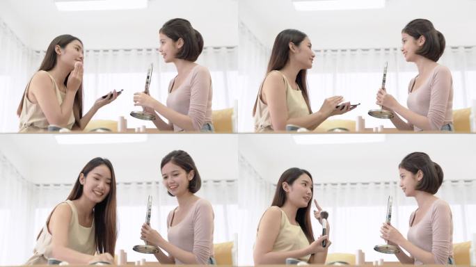 一个亚洲女人在卧室里用化妆品刷，她的朋友拿着镜子。
