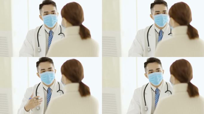 男医生戴口罩及向女病人解释诊断