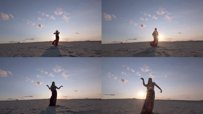 日落时分在沙滩上跳中东舞的年轻漂亮女子.