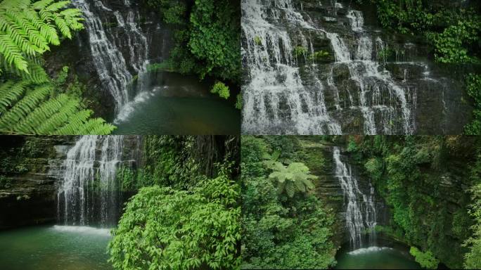 航拍山林中的瀑布流水绿叶水