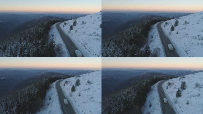 无人机沿着雪地雪地山路，靠近冰冻的常绿森林，全景尽收眼底