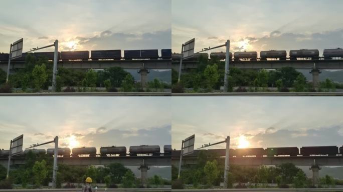 黄昏火车经过桥面朝阳逆光火车开过立交桥