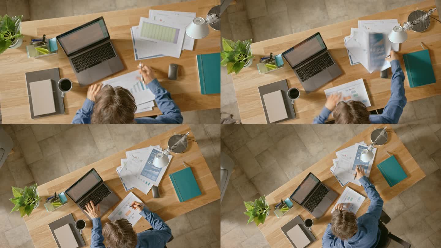 坐在办公室办公桌前的商人使用笔记本电脑，使用公司战略文档、更正图表、绘图和统计数据。顶视图 放大缩小